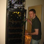 The man has a wine fridge