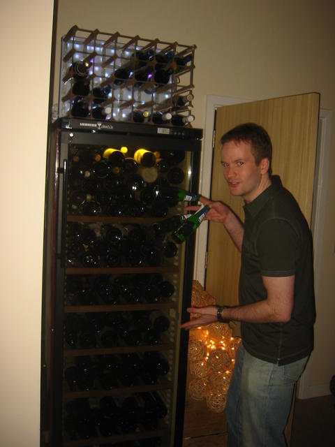 The man has a wine fridge